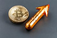 Golden cryptocurrency coin with upward pointing arrow symbolizing rising value and market growth trend on dark background.