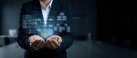 Professional businessman presenting holographic digital interface with data analytics and technology icons floating above hands in modern office environment.