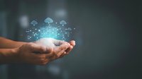 Hands holding glowing cloud computing network with digital icons, representing data storage, connectivity, and technology infrastructure solutions.