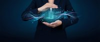 Businessman in dark suit holding glowing digital data stream between hands against blue background, representing technology innovation and data management solutions.
