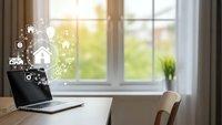 Modern laptop displaying smart home automation icons on wooden desk near bright window with green outdoor view for remote work and technology control.