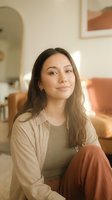 Young woman relaxing at home in cozy living room with warm lighting and modern decor. Casual lifestyle portrait for wellness and comfort concepts.