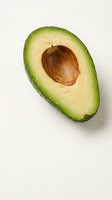 Fresh ripe avocado half with pit on white background isolated for healthy food design projects and culinary content.