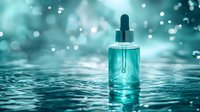 Glass dropper bottle with turquoise serum on water surface against blurred bokeh background, reflecting spa wellness and skincare concept.