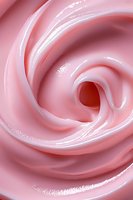 Soft pink swirling cream texture in macro shot showing smooth glossy surface with gentle curves and spiral pattern. Suitable for beauty and cosmetic industry backgrounds.