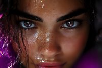Intense close-up portrait showing expressive eyes, freckles, and wet skin effect with dramatic lighting and purple accent highlights creating mysterious atmosphere.