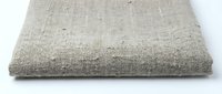 Natural linen fabric texture background with woven fibers pattern for textile design projects and craft applications.