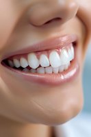 Close-up of bright white healthy teeth and natural pink lips showing genuine smile. Dental care and oral hygiene concept for dentistry and cosmetic services.