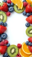 Fresh mixed berries and fruits frame on white background with copy space for healthy eating and nutrition concepts.