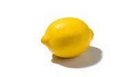 Fresh bright yellow lemon with textured skin and natural shadow on white background, suitable for food, beverage, health and culinary design projects.