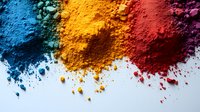 Vibrant colorful powder pigments scattered on white background - blue, yellow, orange and red holi festival colors creating artistic composition.