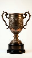 Ornate bronze trophy cup with decorative handles and engraved floral patterns on black base, isolated on white background for awards and achievement designs.