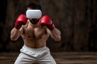 Athletic Caucasian male boxer in fighting stance wearing red gloves and white headband against dark background for sports and fitness concepts.