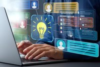 Hands typing on laptop with glowing digital interface displaying lightbulb icon and user profiles for innovation and technology concepts.
