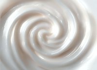 Smooth creamy white spiral texture with soft swirling pattern creates elegant abstract background for luxury cosmetic and skincare product designs.