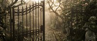 Ornate wrought iron gate opens to mysterious cobblestone path through misty autumn garden with bare trees and fallen leaves creating atmospheric entrance scene.