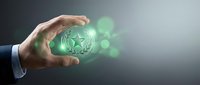 Global business growth and expansion concept with hand holding glowing green globe surrounded by bokeh lights, representing worldwide commerce and digital connectivity.