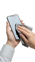 Hands of a woman with light skin tone cleaning smartphone screen with microfiber cloth on white background, isolated for design use.