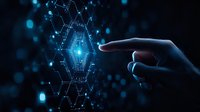 Silhouetted hand reaching towards glowing blue hexagonal hologram with connected nodes against dark background, representing digital transformation and innovation.