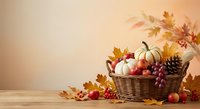 Autumn harvest basket with pumpkins, apples and colorful fall leaves on wooden table with warm seasonal lighting for thanksgiving decoration.