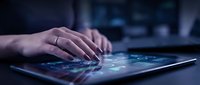 Woman's hands with ring typing on glowing tablet screen in dark room, digital data interface visible, tech and business concept.