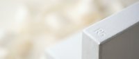 Modern minimalist white concrete block with number 23 engraved on clean geometric surface against soft blurred background for architectural design projects.