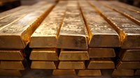 Stack of shiny gold bars arranged in rows showing wealth and precious metal investment value, with detailed surface texture and metallic reflection.