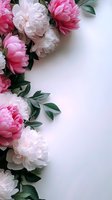 Pink and white peonies with green leaves create an elegant border frame on white background, offering space for text or design elements.