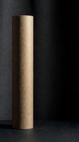 Brown kraft paper roll standing vertically against dark background for packaging, wrapping, crafts and shipping applications.