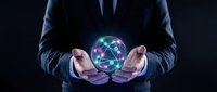 Professional businessman in dark suit holding glowing digital sphere with network connections, representing technology innovation and data management solutions.