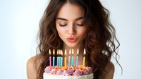 Young woman blowing out colorful birthday candles on decorated cake with pink frosting and rainbow candles for celebration party.