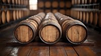 Wooden wine barrels lined up in dark cellar with dramatic lighting. Traditional oak casks for aging wine and spirits on wooden floor. Rustic winery atmosphere.
