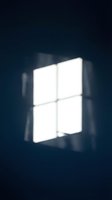Bright window with four illuminated panes casting light through dark interior space, suitable for architectural, interior design, and atmospheric backgrounds.