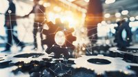Glowing gear wheels and network connections on blurred industrial background illustrate technological advancement and business process automation.
