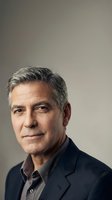 Middle-aged man with gray hair and facial lines, wearing dark blazer over casual shirt, isolated against neutral background for corporate and professional use.