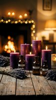 Purple candles and essential oil bottles with lavender sprigs on rustic wooden table near cozy fireplace creating warm relaxing spa atmosphere for aromatherapy.