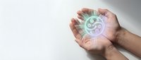 Close-up of hands holding glowing digital currency symbol, representing financial technology, blockchain, cryptocurrency investment, and modern digital money concepts.