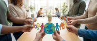 Diverse group of people holding colorful paper cutout figures around smiling globe, representing unity, teamwork, and global community collaboration in modern office environment.