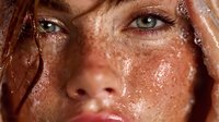 Close-up portrait of young Caucasian woman with freckles and wet skin, natural beauty concept for skincare and cosmetics advertising campaigns.