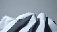 Snow-covered mountain peaks with dramatic shadows and curves against gray sky. Winter landscape with pristine white snow formations and natural alpine terrain.