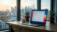 Modern laptop computer on wooden desk by office window with city skyline view, coffee cup and plants creating productive workspace atmosphere.