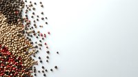 Scattered peppercorns in various colors - black, white, pink, and red - creating diagonal border composition on white background, isolated for culinary designs.