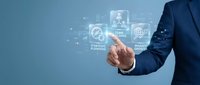 Businessman in dark suit touching digital interface with startup planning, team building, and market analysis icons on blue background.