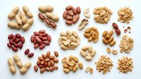 Assorted nuts and legumes including peanuts, almonds, cashews, and red beans arranged on white background, suitable for food, nutrition, and healthy eating content.