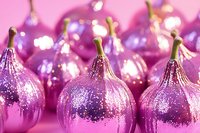 Shiny metallic ornaments with glitter finish and gold stems arranged on pink background, suitable for holiday decorations and festive designs.