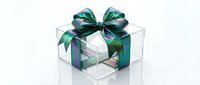 Transparent gift box with emerald green satin ribbon bow isolated on white background for holiday packaging design and festive decoration concepts.
