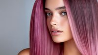 Young woman with trendy pink purple ombre hair color and natural makeup looking at camera. Modern hair coloring and beauty salon concept.