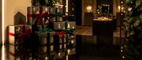 Wrapped Christmas presents under decorated tree in cozy living room with warm lighting creating festive holiday atmosphere for seasonal celebrations.