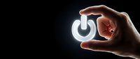 Hand holding glowing power button symbol on dark background, representing energy, technology, startup, and control concepts for business and digital design projects.