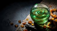 Green magical potion with golden sparkles in glass sphere on wooden surface with amber crystals for fantasy gaming and mystical storytelling concepts.